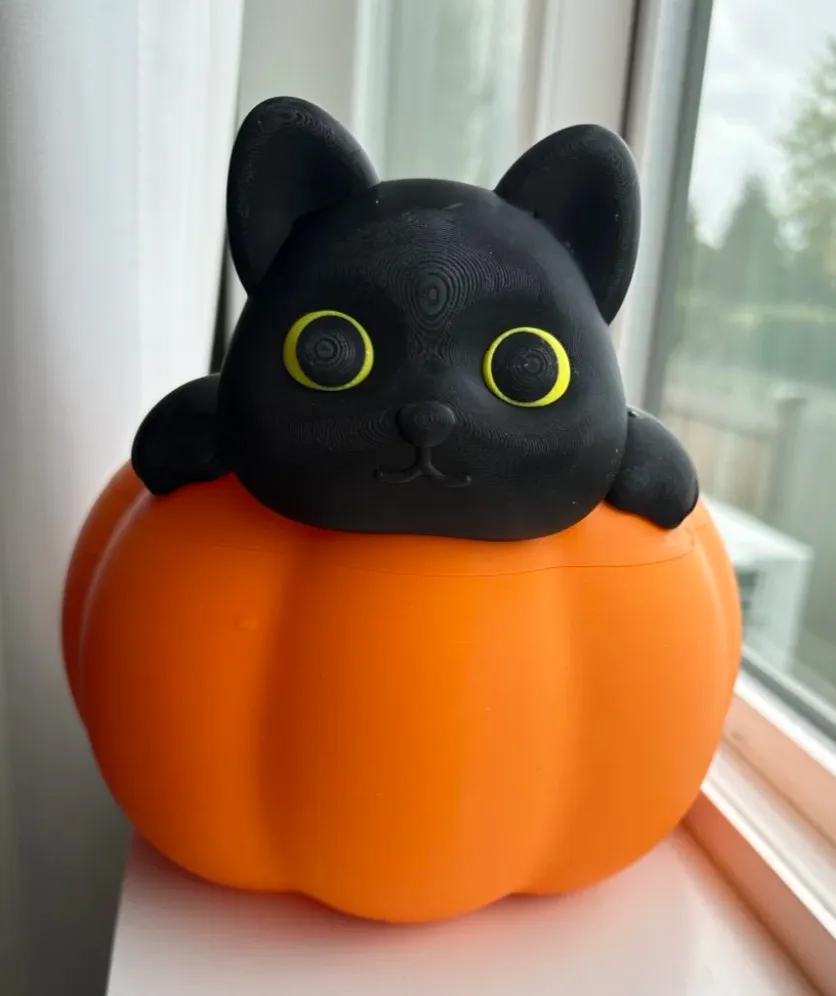 Front view of pumpkin-shaped 3D printed container with black cat figure using Bambu Lab PLA Basic Pumpkin Orange filament 10301