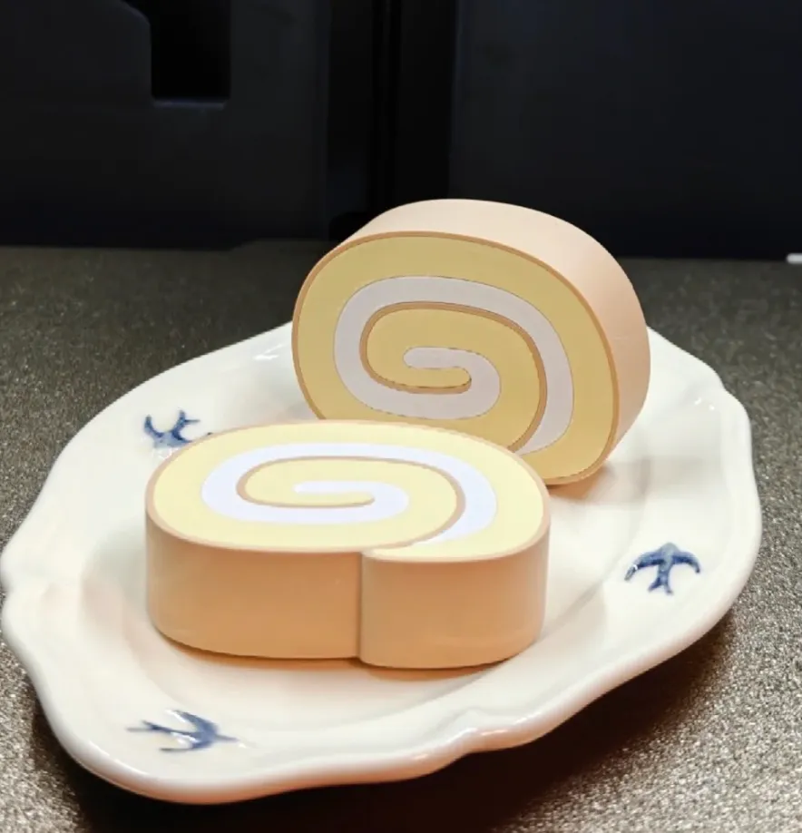 3D printed Swiss roll cake model with ivory white spiral layers made using Bambu Lab PLA Matte Ivory White Filament with Spool Color Code 11100