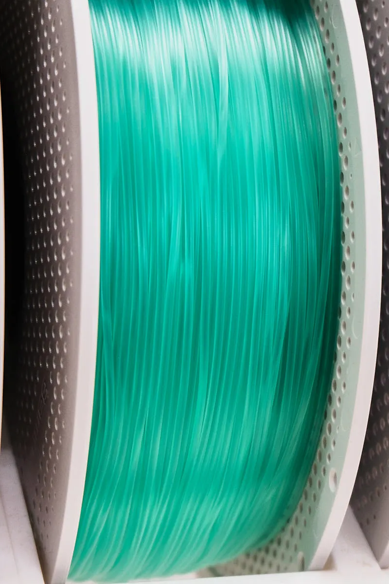 Side view of Bambu Lab PLA Translucent Light Jade filament 13510 on spool, highlighting filament thickness and light transmission