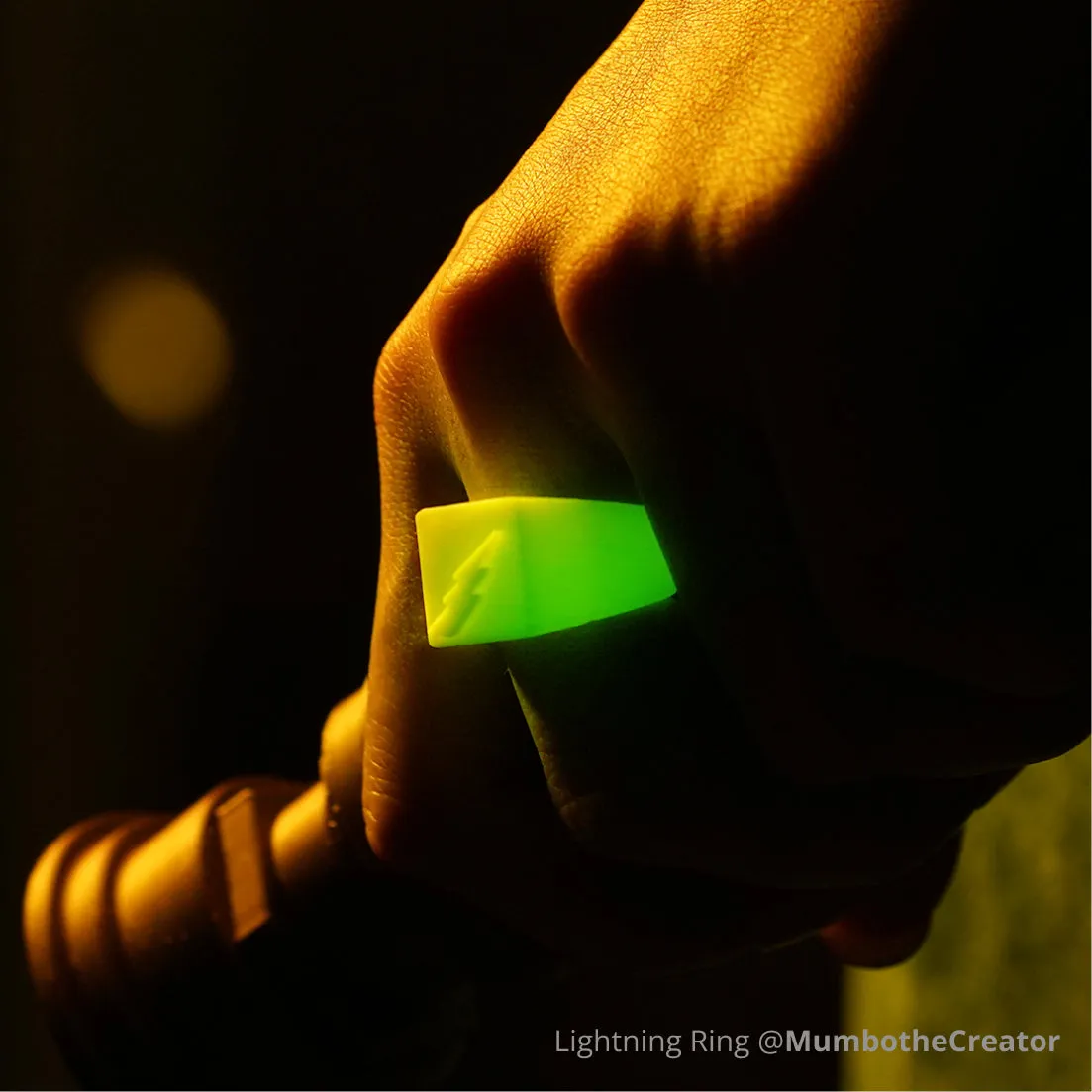 Glow-in-the-dark lightning ring 3D printed with Bambu PLA Glow filament, emitting bright green light in low-light conditions