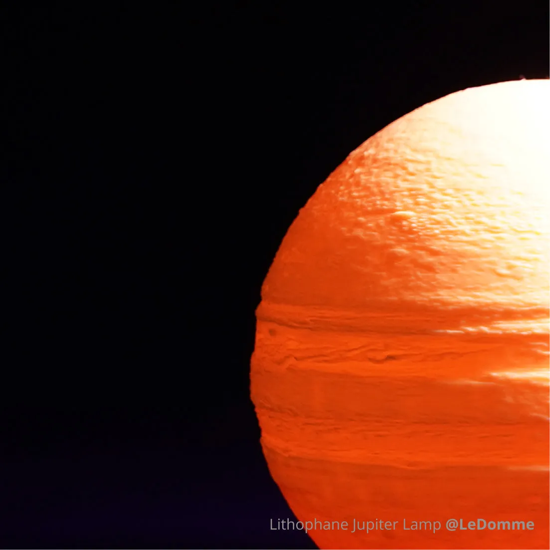 Lithophane Jupiter lamp 3D printed with Bambu PLA Glow filament, showing layered surface texture and warm glow in darkness