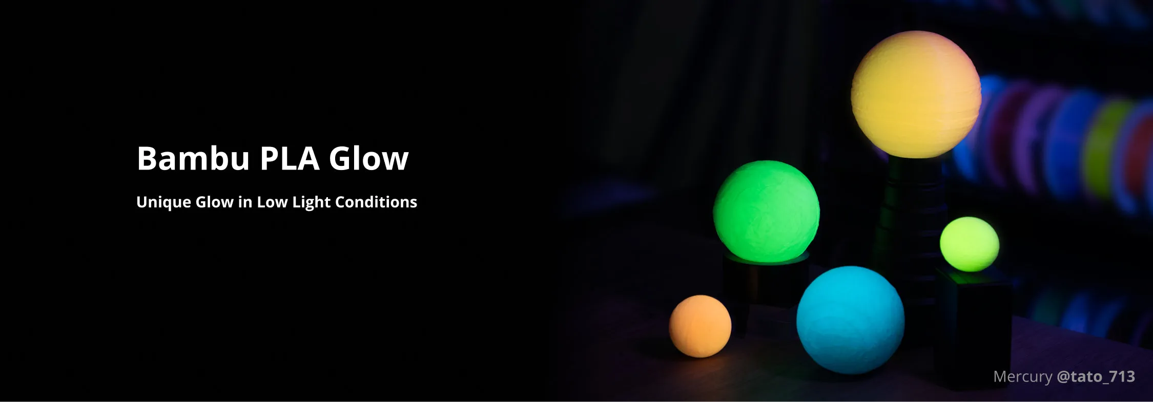 Multiple glow-in-the-dark spheres printed with Bambu PLA Glow filament in green, blue, and yellow colors