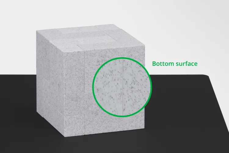 Close-up of bottom surface detail on 3D printed cube using Bambu Smooth PEI build plate, showing smooth and matte finish