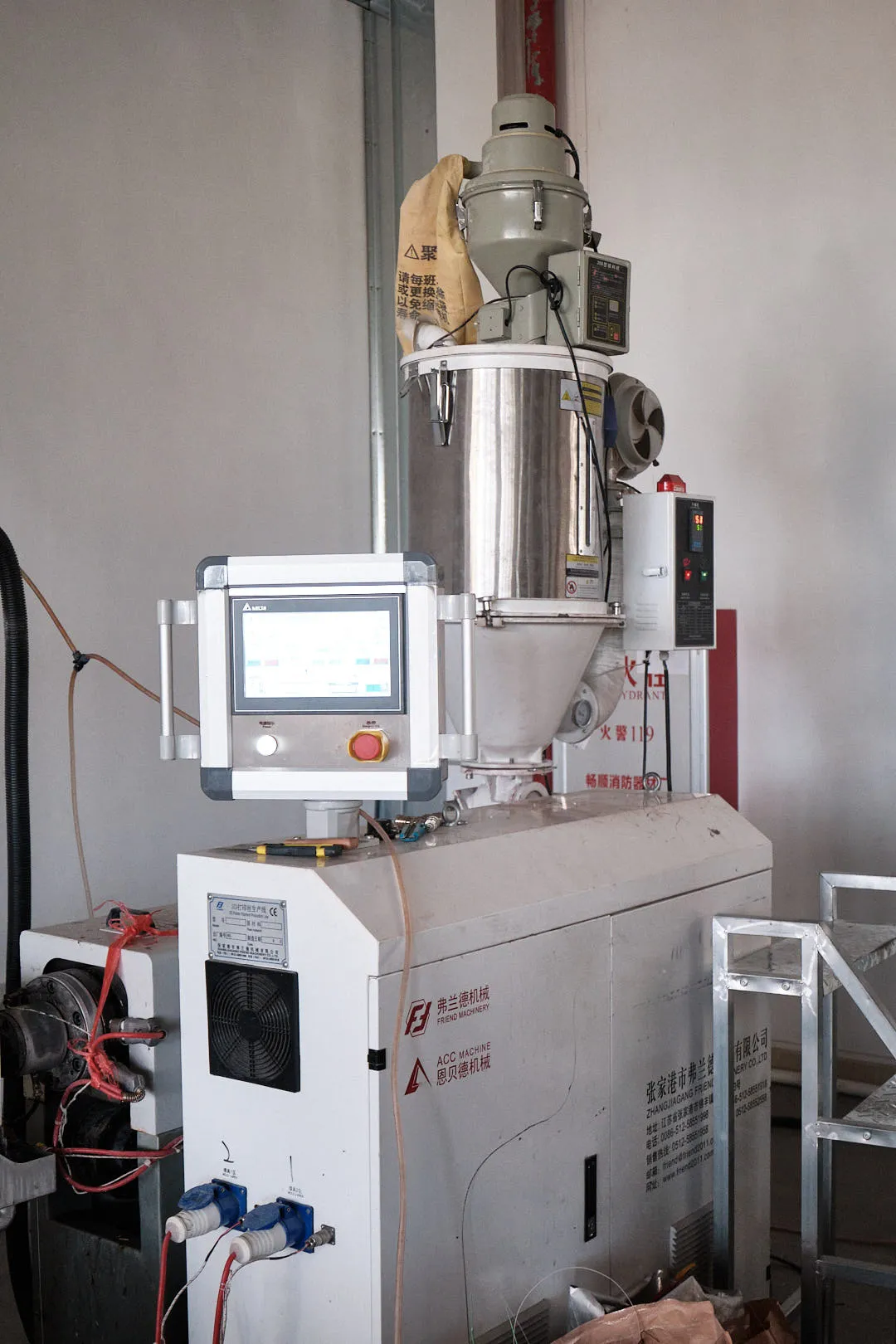 Plastic filament raw material fed into an industrial extrusion machine preparing to be extruded into continuous filament for 3D printing