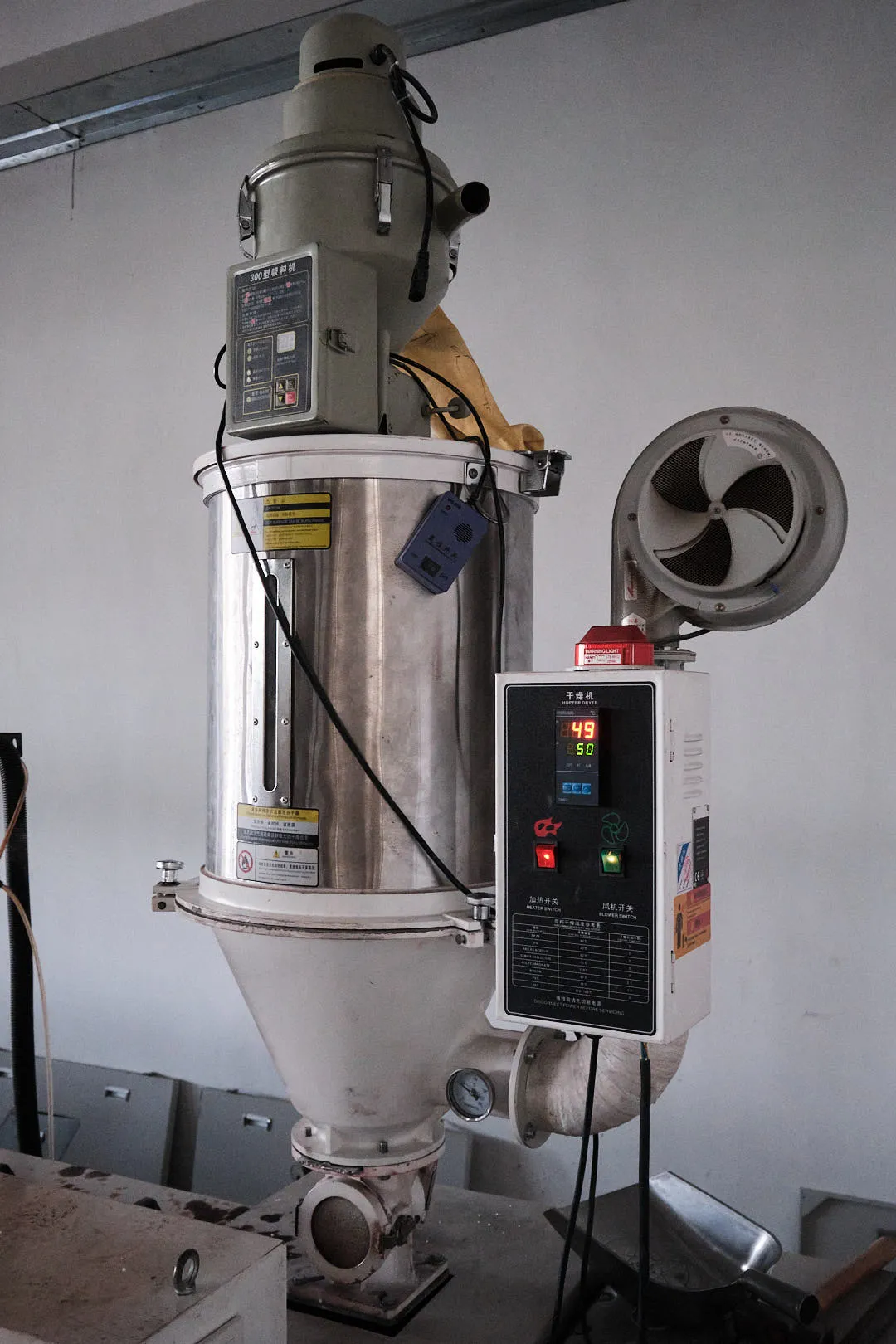 Industrial hopper dryer drying plastic pellets before feeding them into a filament extrusion machine for 3D printing material production