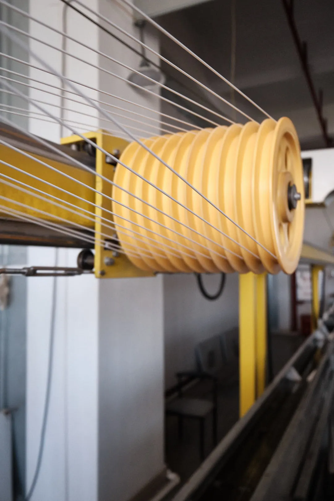 Multiple 3D printing filament lines guided across a multi-channel wheel before entering the spooling system