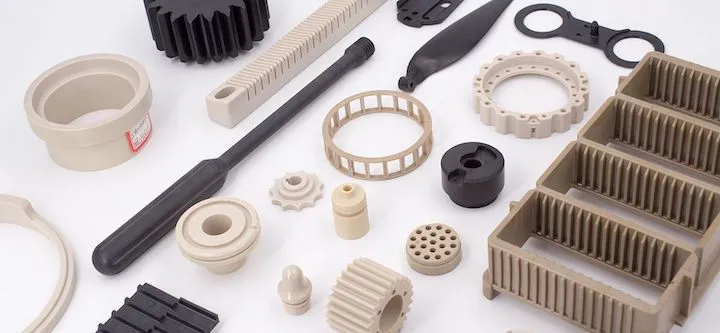 Various high-strength PEEK plastic components including gears, housings, structural brackets, and precision mechanical parts for industrial applications.