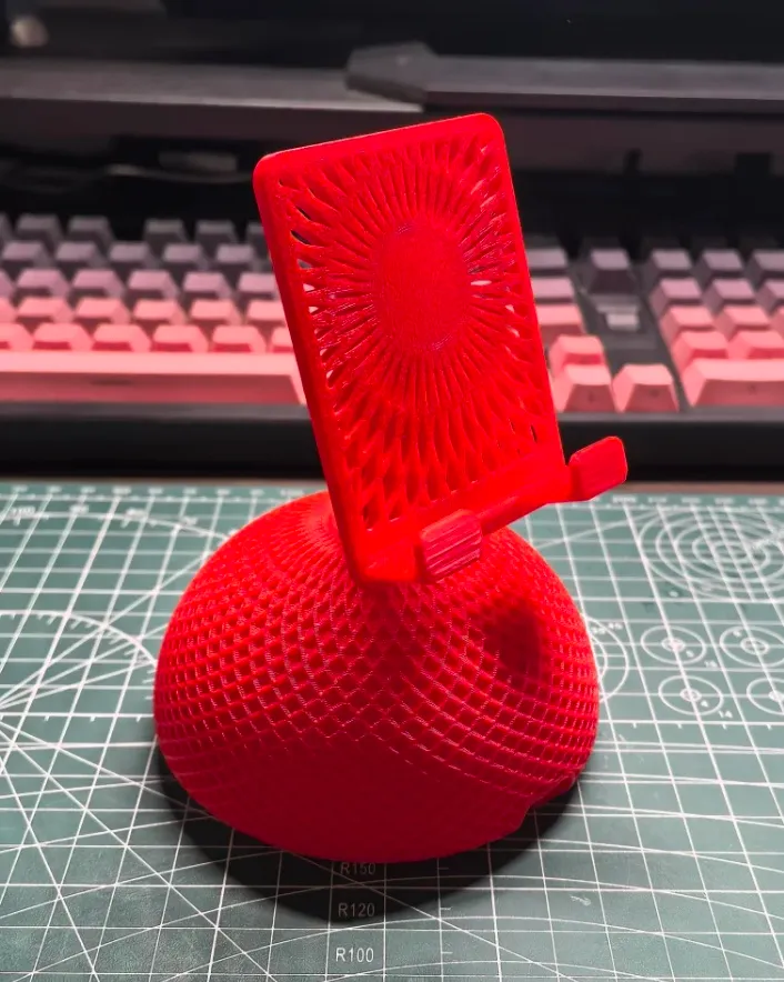 PETG Basic Red filament 3D printed phone stand and textured base showing clean layers and vibrant color
