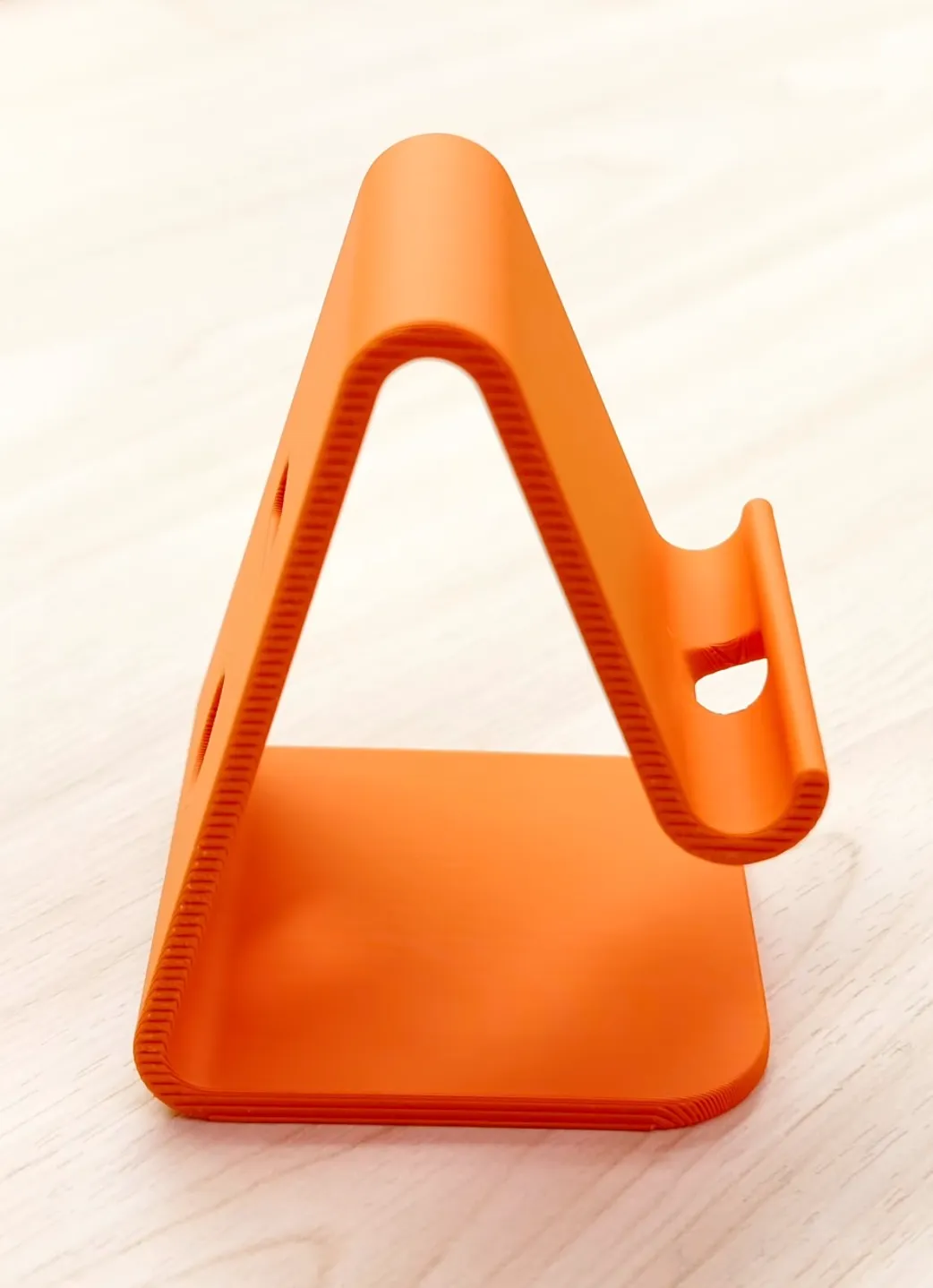 3D printed minimalist A-frame stand made with Bambu Lab PLA Lite Orange filament 16301, showing smooth surface finish and clean layer lines
