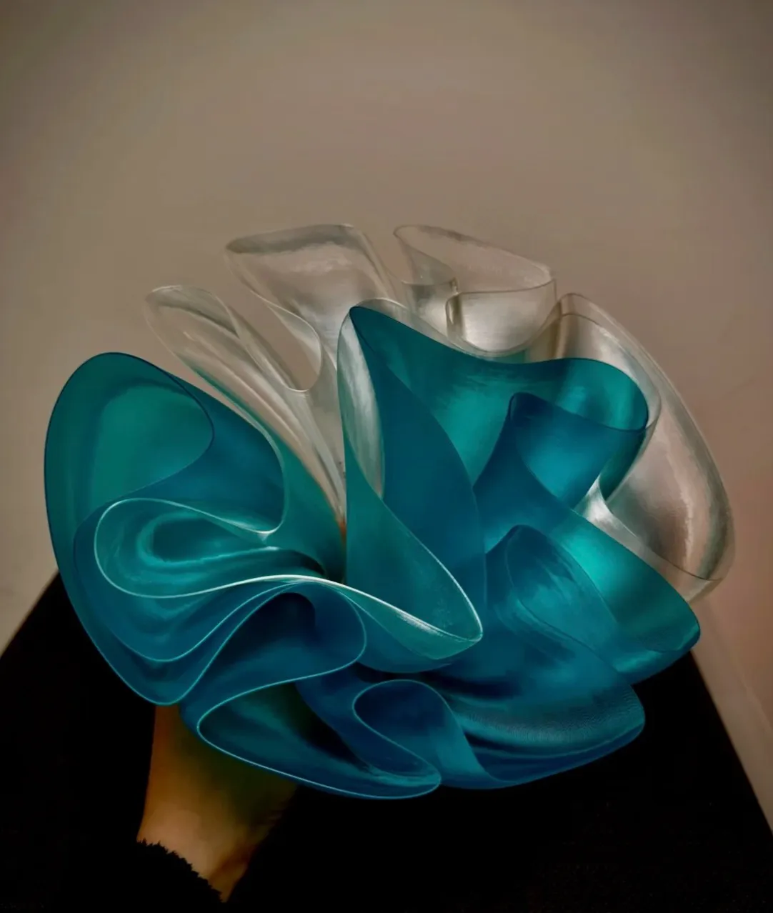 Layered artistic structure printed using Bambu Lab PLA Translucent Teal Filament with Spool 13612 combined with translucent white material.