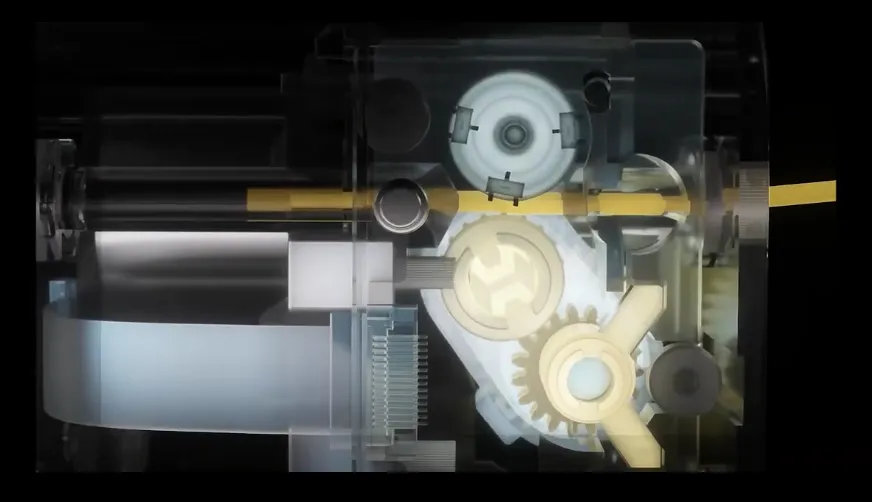 Transparent view of Snapmaker U1 automatic filament system showing internal drive gears and feeding mechanism