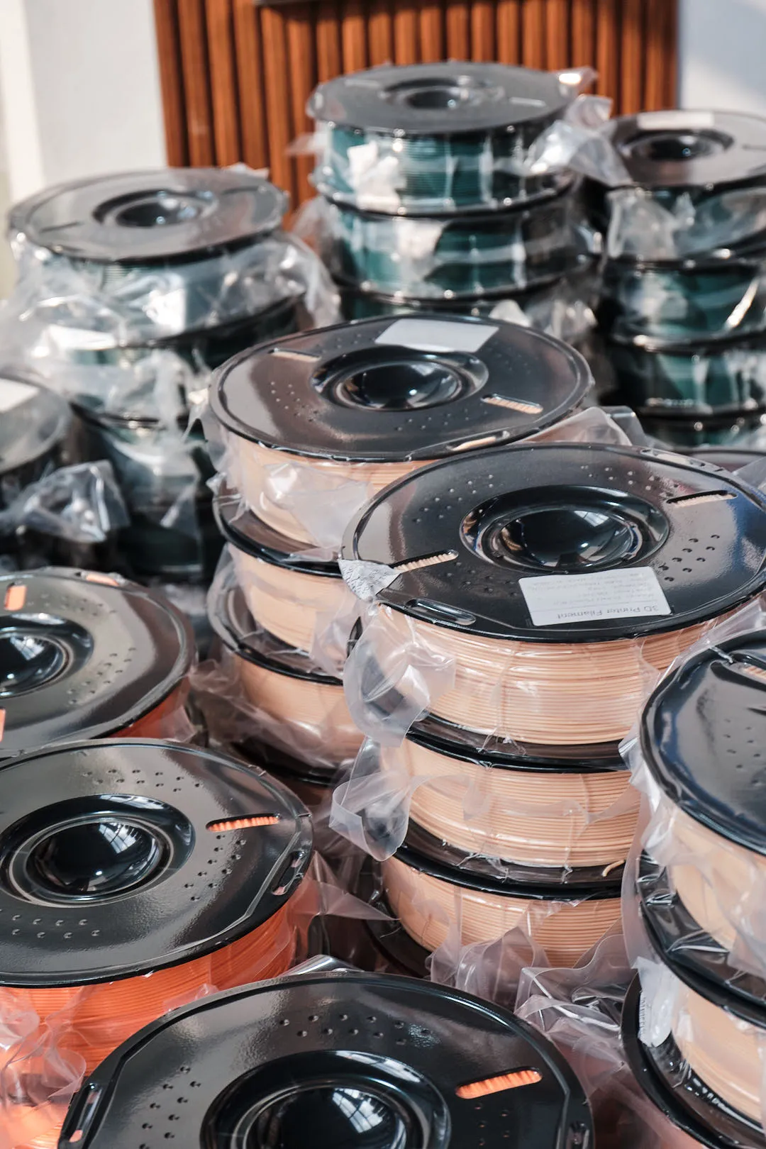 Vacuum-packaged 3D printer filament spools prepared for storage and distribution
