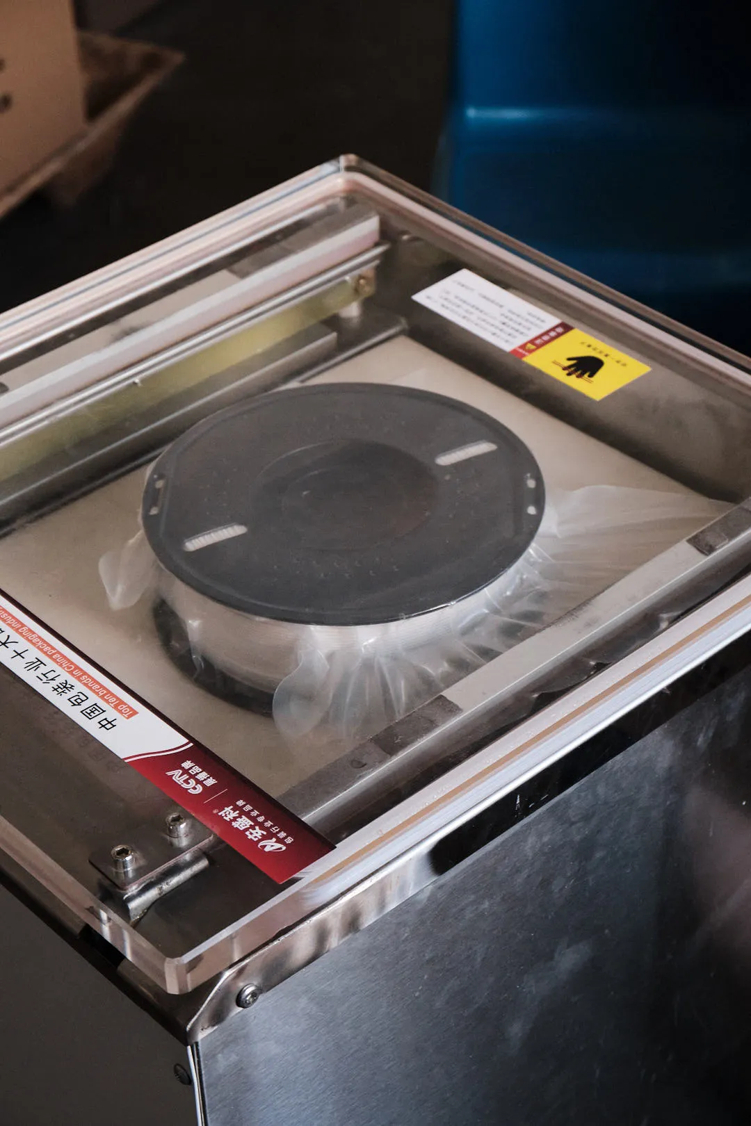 Vacuum-sealed 3D printing filament spool inside a sealed plastic bag after packaging
