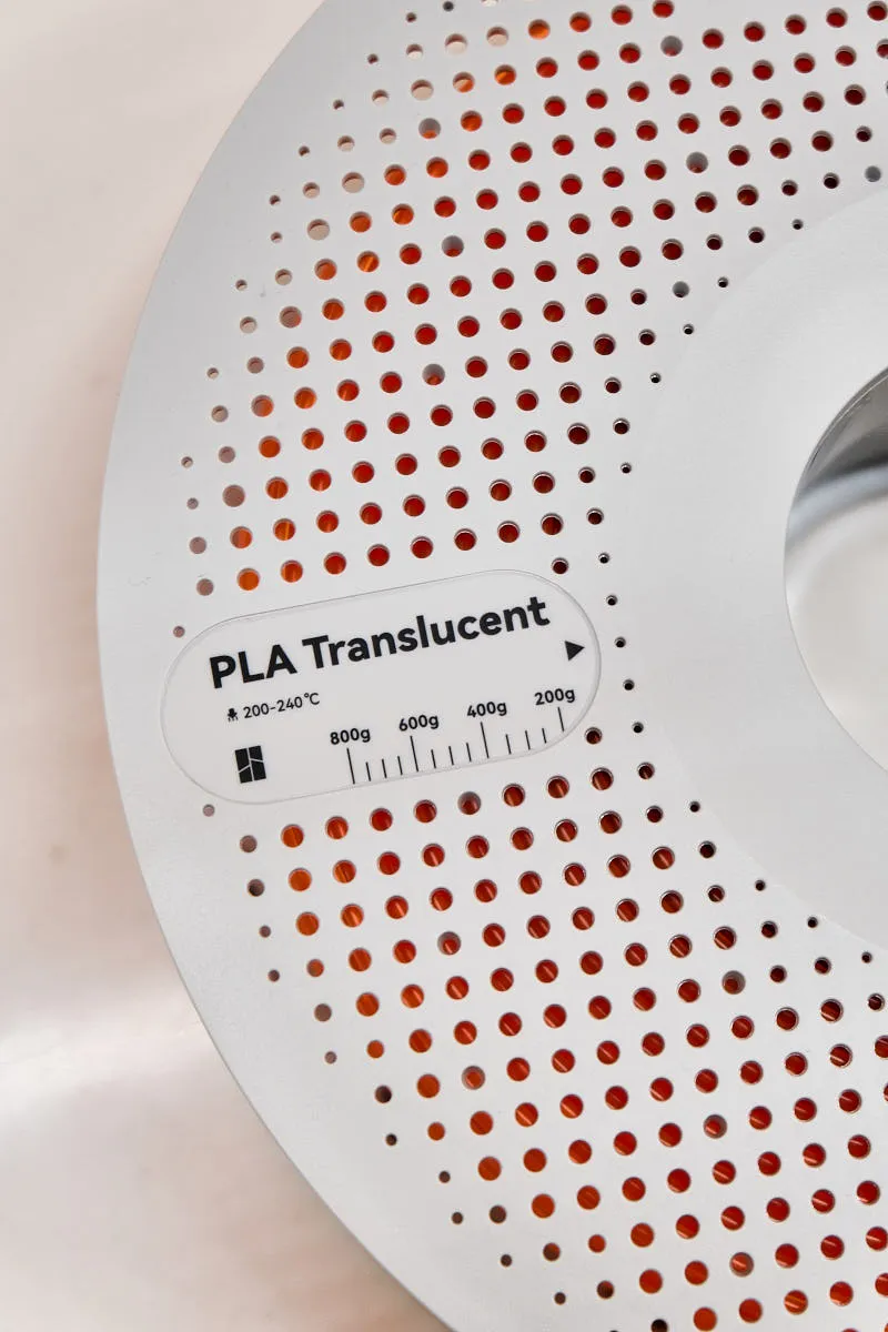 Bambu Lab PLA Translucent Orange filament spool label showing material type, temperature range, and remaining weight scale