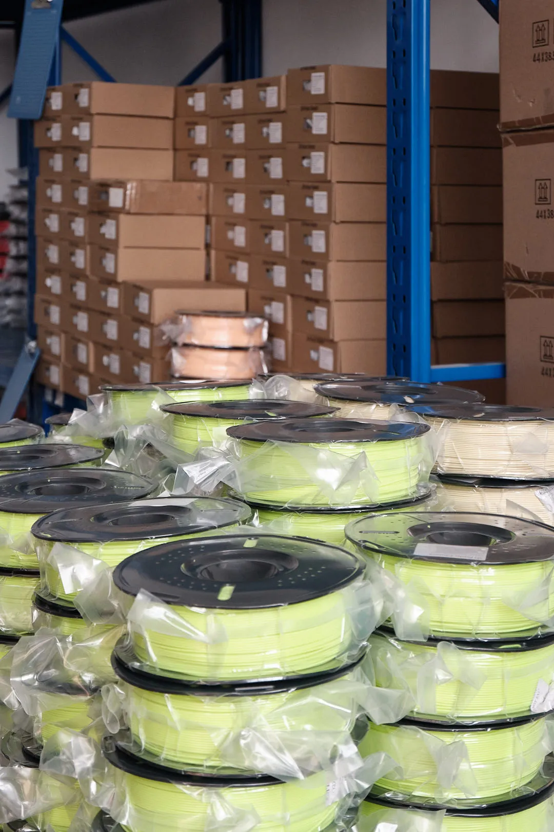 Vacuum sealed 3D printer filament spools stored in warehouse before shipping