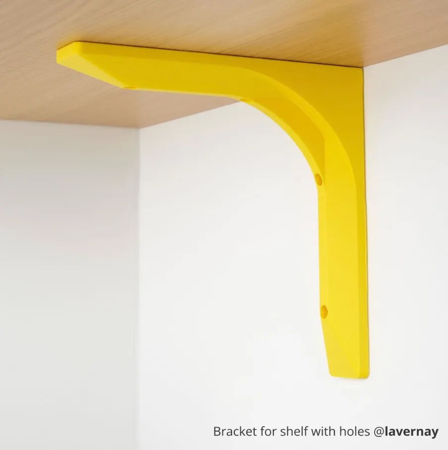 yellow shelf support bracket installed under wooden shelf 3D printed using Bambu Lab ABS-GF filament