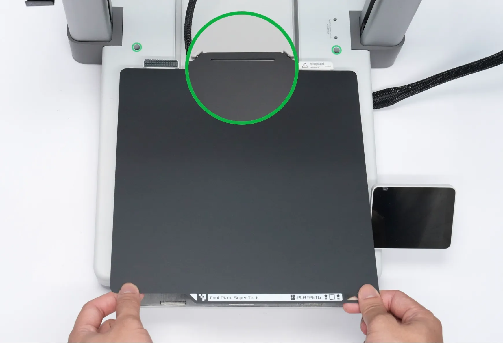 aligning Bambu Cool Plate SuperTack build plate with printer platform positioning points before installation