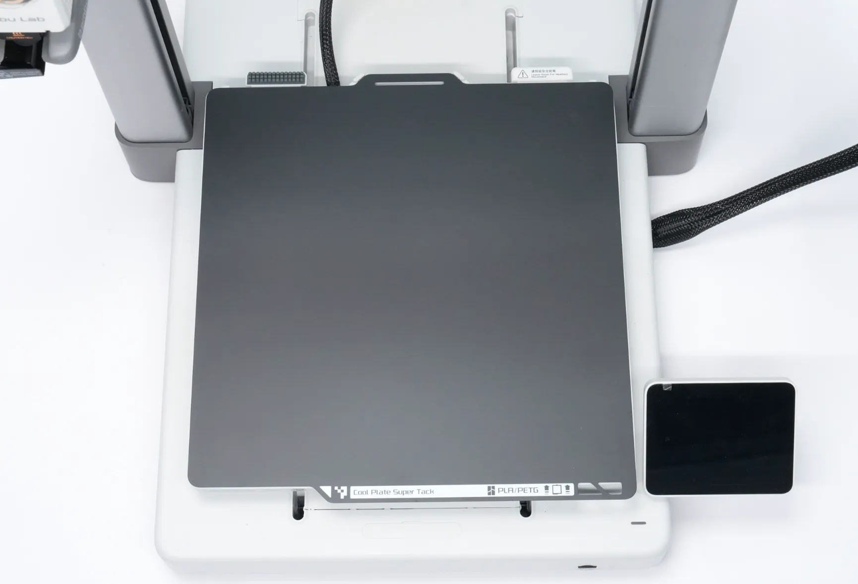 securing Bambu Cool Plate SuperTack onto magnetic build platform by lowering and positioning plate