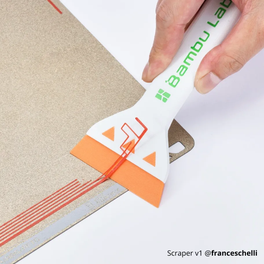 3D printed scraper tool made with Bambu Lab ABS-GF filament removing printed lines from a textured build plate