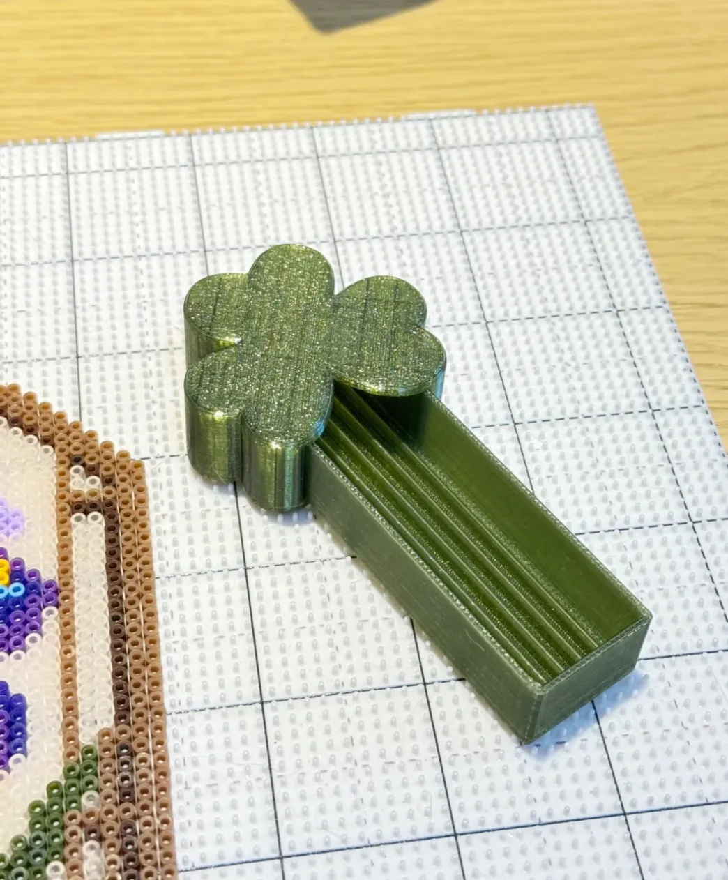 Small functional test part printed with Bambu Lab PETG Translucent Olive Green Filament Color Code 32500 on grid build surface.