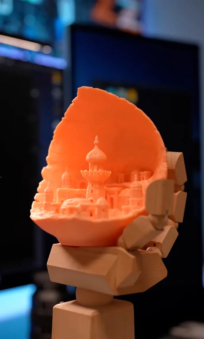 Glowing city relief lamp 3D print held by a wooden clamp, made with Bambu Lab PLA Glow Orange Filament 1.75mm 1kg/Spool (Color Code:15300) in a workshop setting