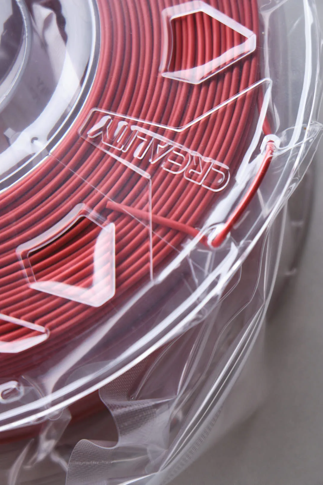 detail of red filament winding on Creality CR-PLA Carbon Red filament spool edge