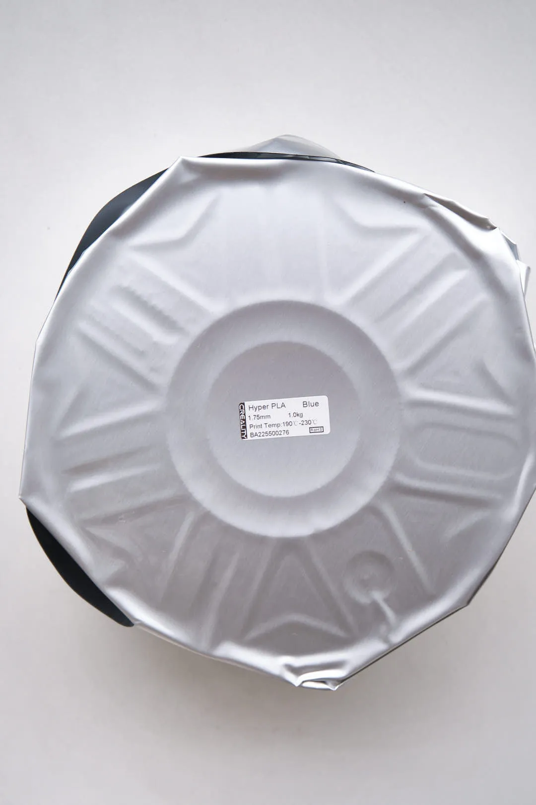 Front view of Creality Hyper PLA RFID blue filament spool sealed in silver packaging bag with product label