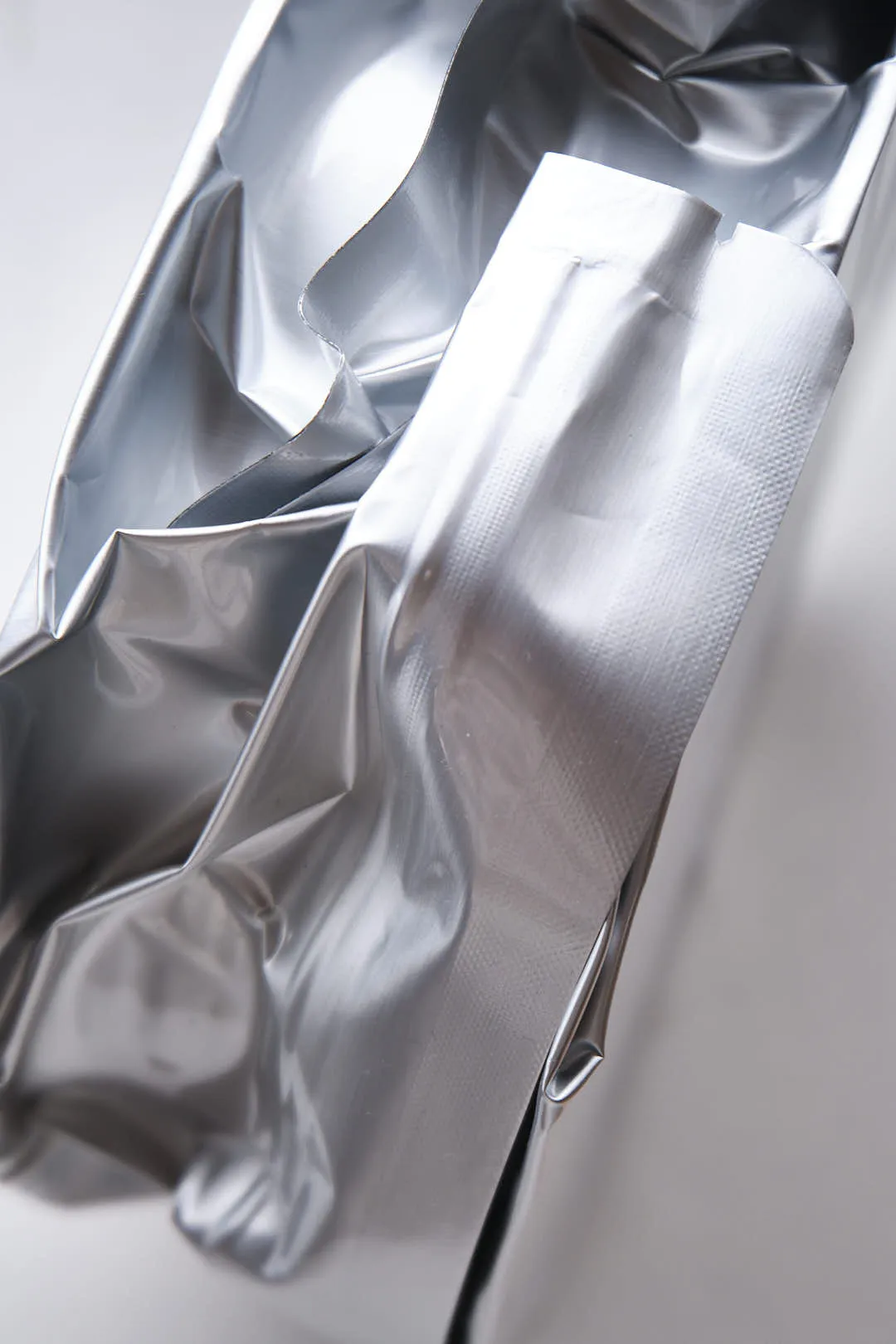 Close-up of vacuum sealed foil bag interior used for Creality Hyper PLA RFID filament showing texture and sealing edge