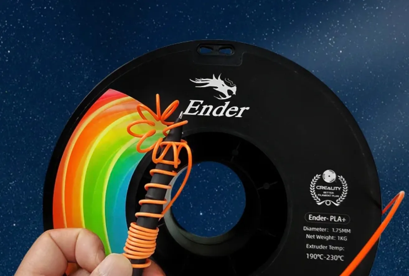 Ender PLA+ filament being bent by hand in front of filament spool