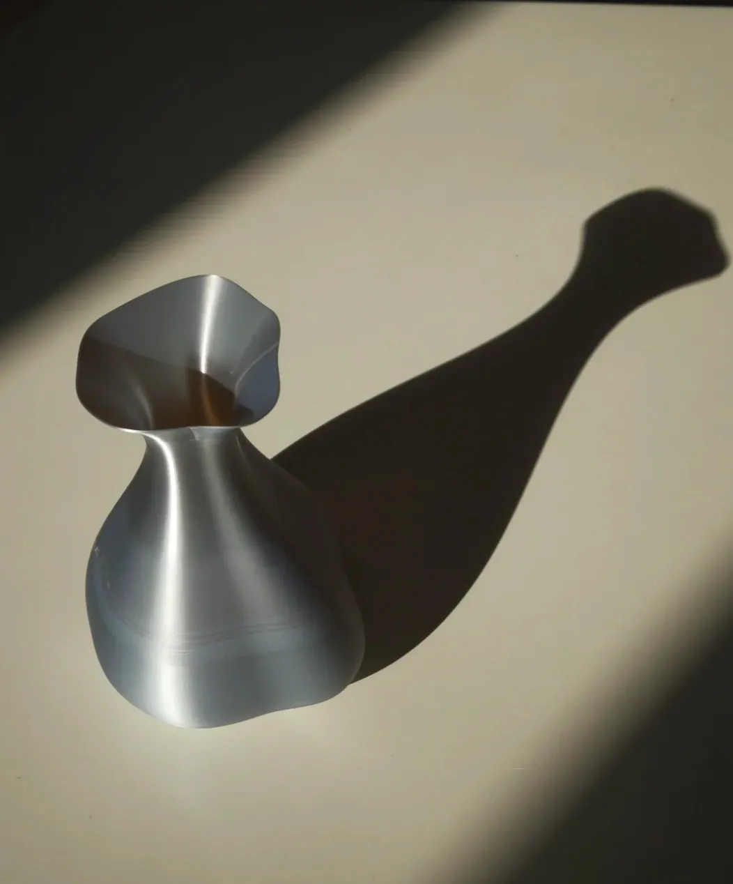 Curved vase printed with Bambu Lab PLA Silk+ Silver Filament 1.75mm 1kg/Spool Color Code 13109 showing reflective metallic silver sheen