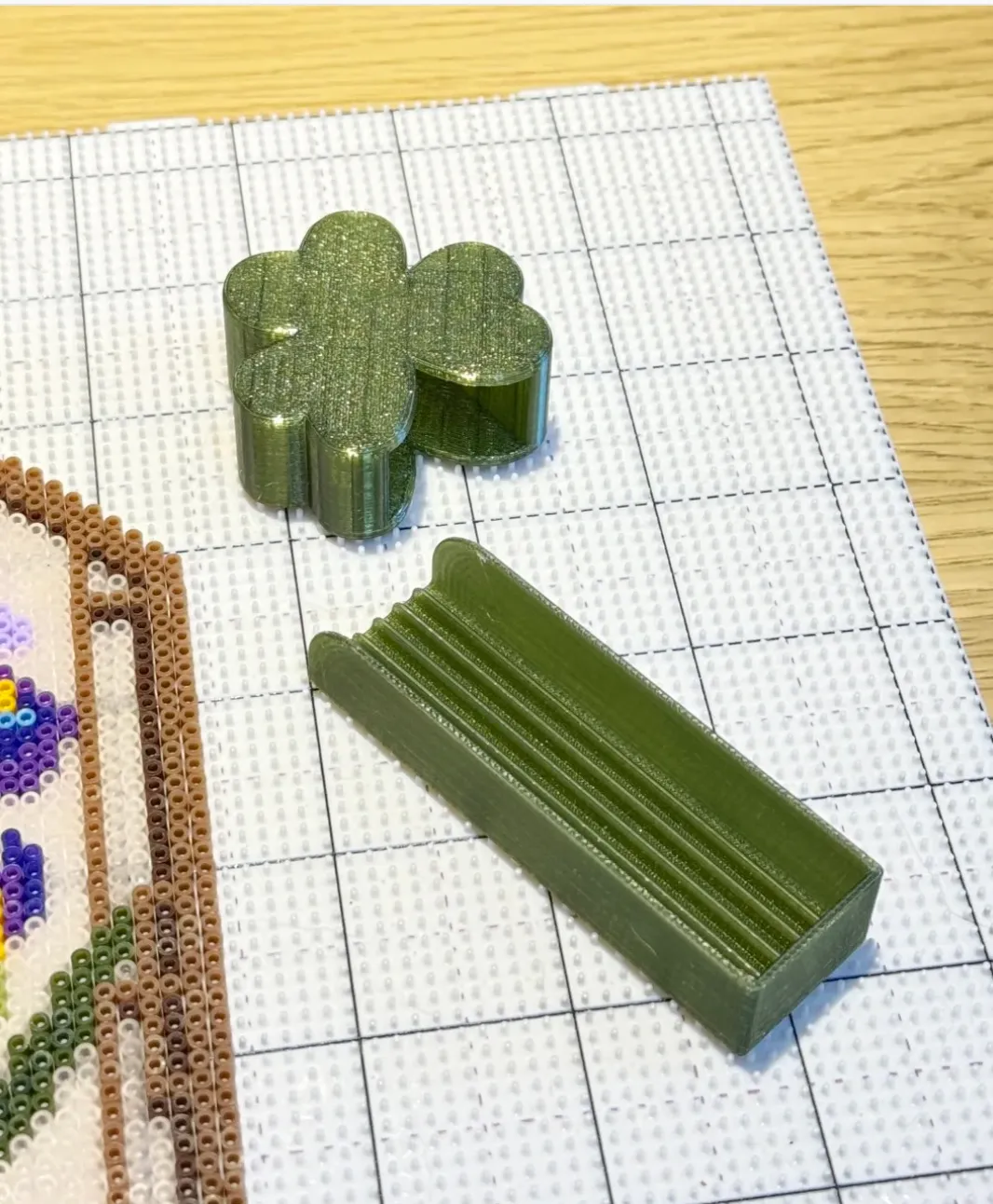 Two-piece structural component printed with Bambu Lab PETG Translucent Olive Green Filament Color Code 32500 showing smooth extrusion lines.