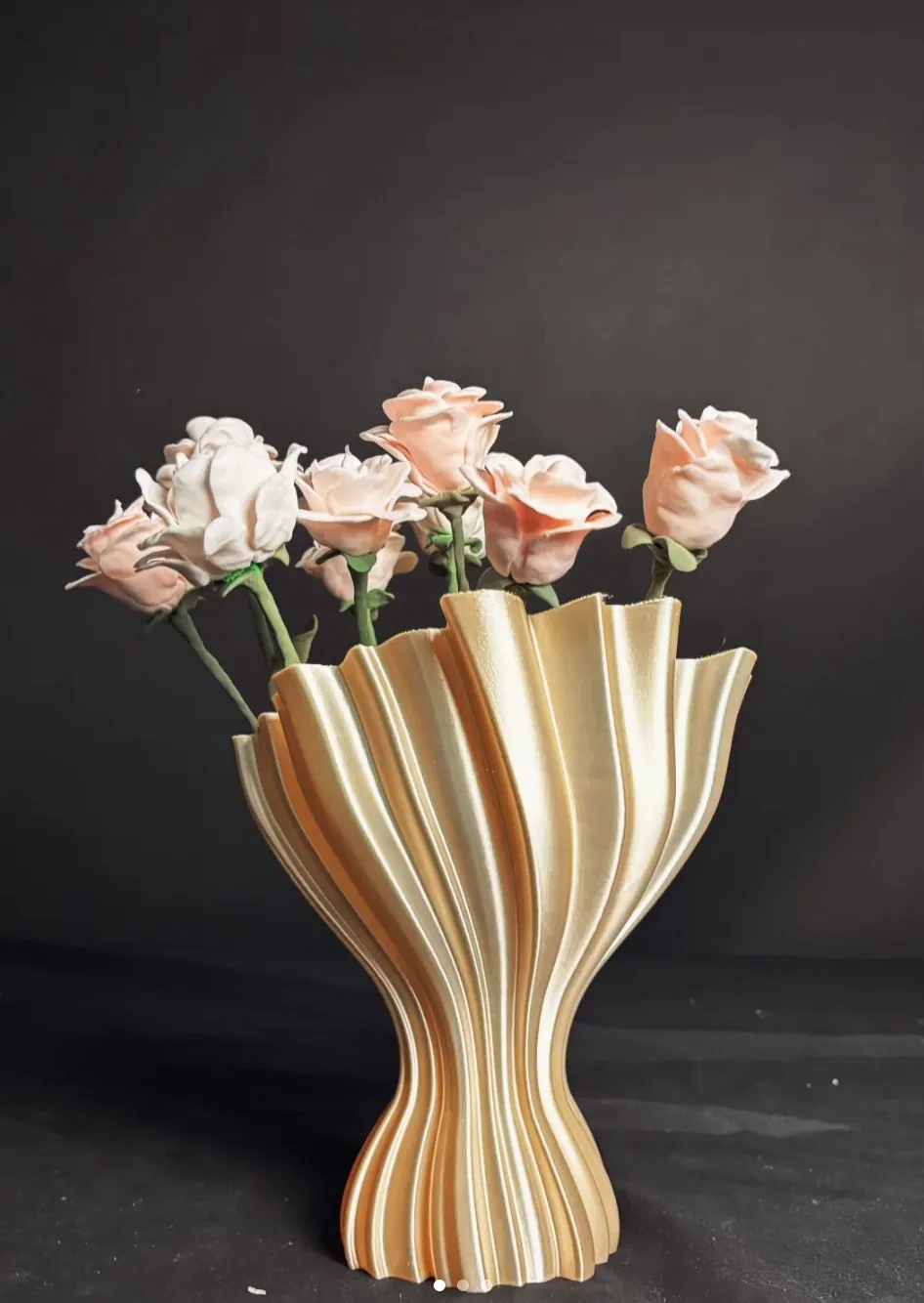 Decorative fluted vase printed with Bambu Lab PLA Silk+ Champagne Filament 13404 holding artificial flowers against dark background.