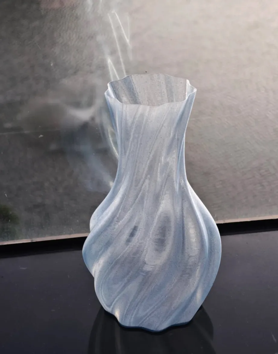 Twisted vase printed with Bambu Lab PLA Translucent Ice Blue Filament with Spool 13610 demonstrating smooth surface quality and soft translucent sheen.