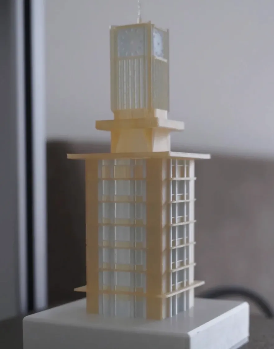 Architectural tower model printed with Bambu Lab PLA Translucent Mellow Yellow Filament with Spool 13410 showing soft translucent yellow tone and fine structural detail.