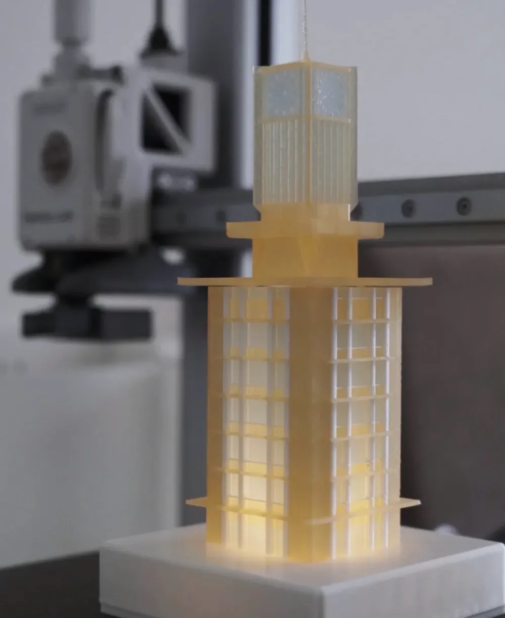 Illuminated architectural model printed with Bambu Lab PLA Translucent Mellow Yellow Filament with Spool 13410 highlighting warm light diffusion and layered translucency.