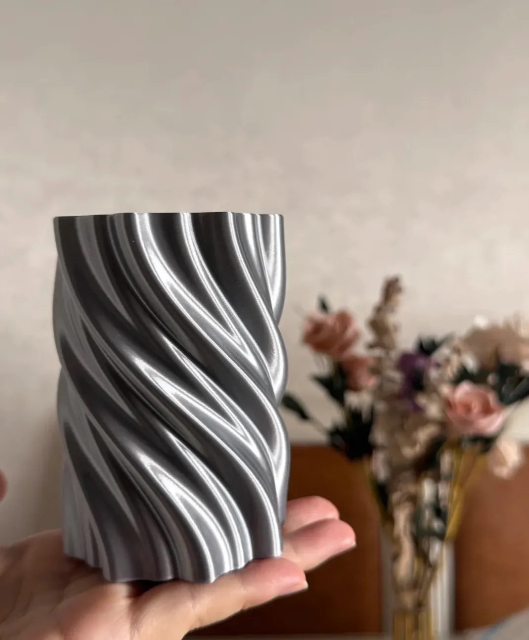 Twisted cylindrical model printed using Bambu Lab PLA Silk+ Silver Filament 1.75mm 1kg/Spool Color Code 13109 with glossy silk silver texture