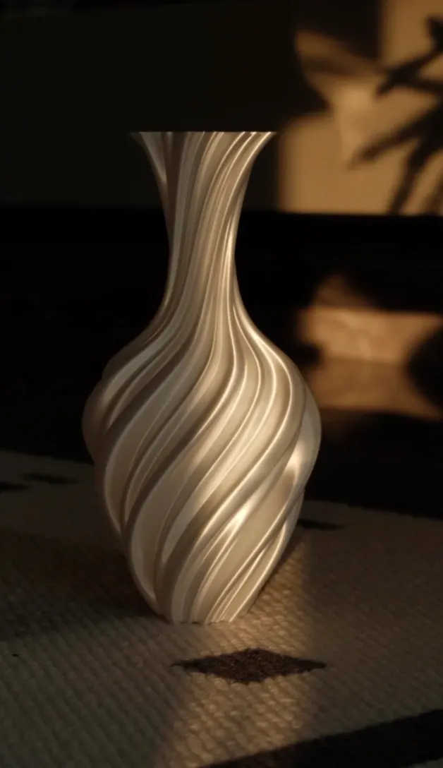 Twisted decorative vase printed in Bambu Lab PLA Silk+ White Filament 1.75mm 1kg/Spool Color Code 13110 with warm reflective sheen