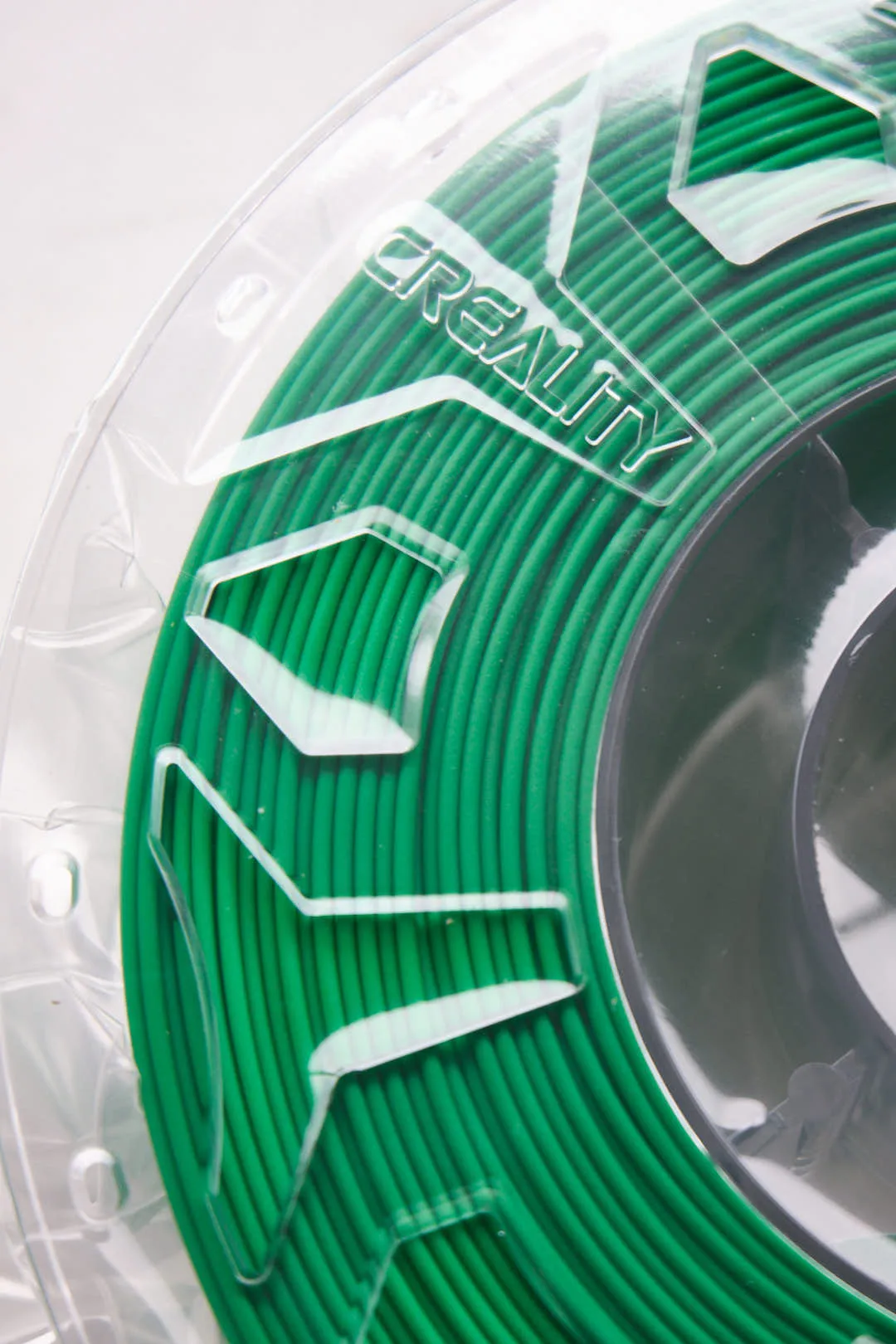 close-up of filament spool edge with Creality logo and green filament coils