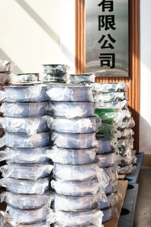 stacked 3d printing filament spools vacuum sealed light blue green bulk filament storage warehouse