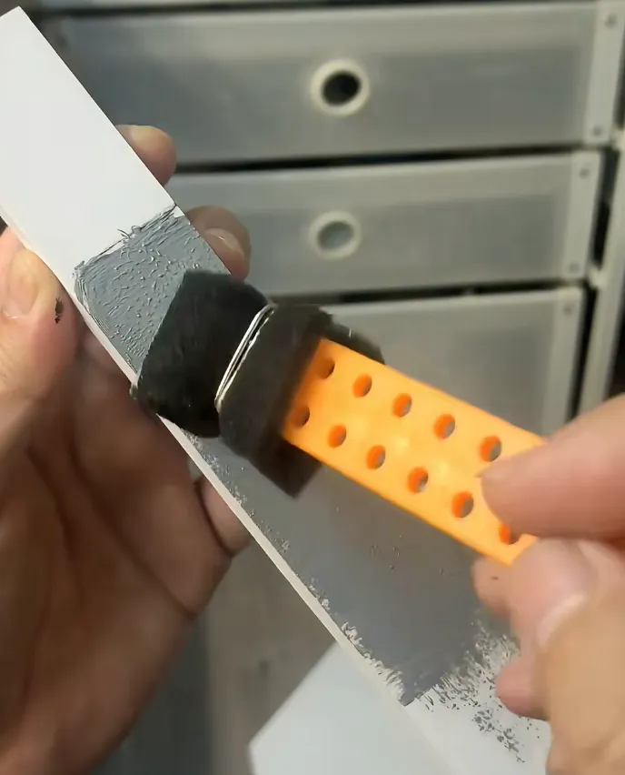 foam brush applying filler putty onto 3D printed PLA surface to smooth layer lines