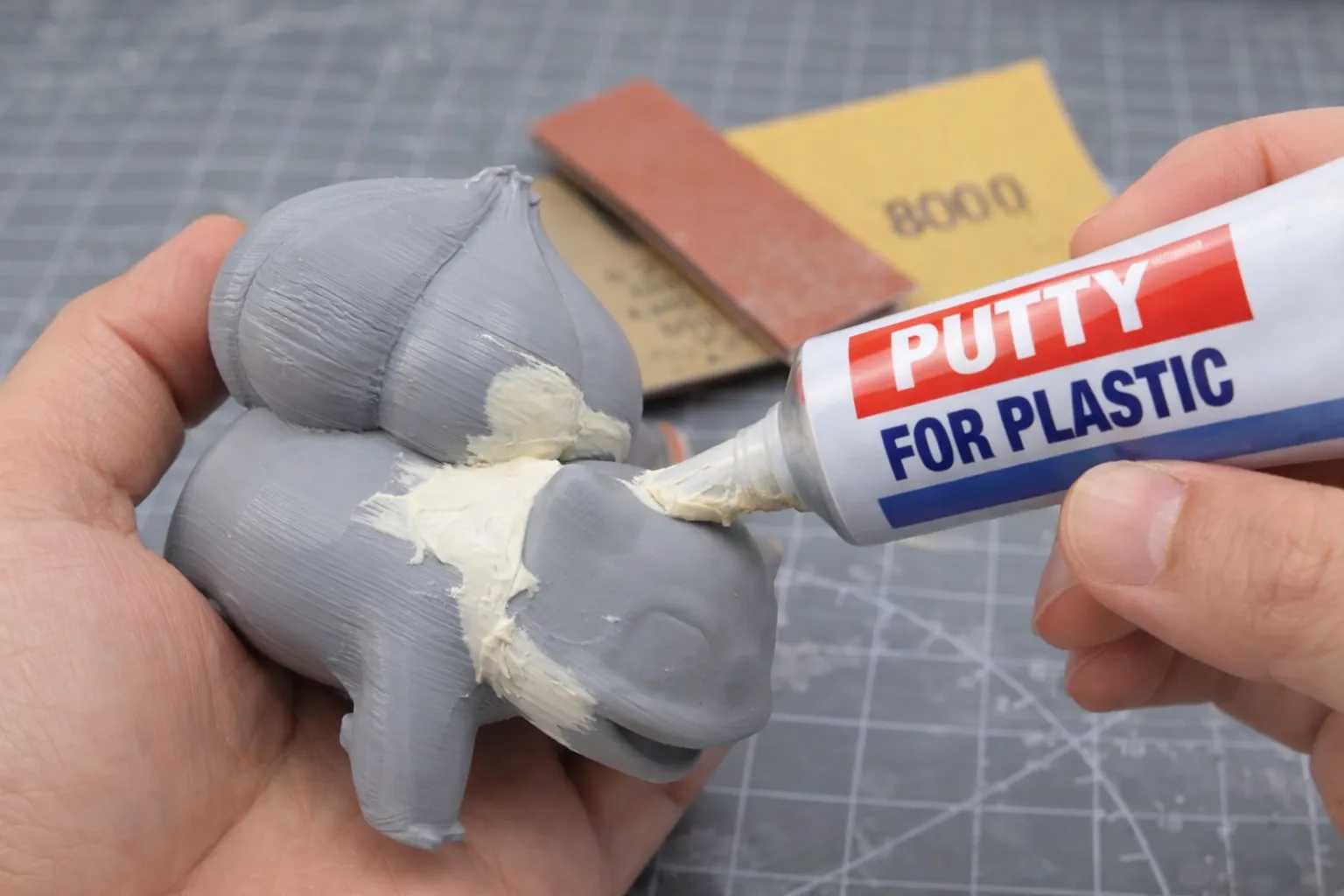 applying filler putty on PLA 3D printed model to smooth surface before painting