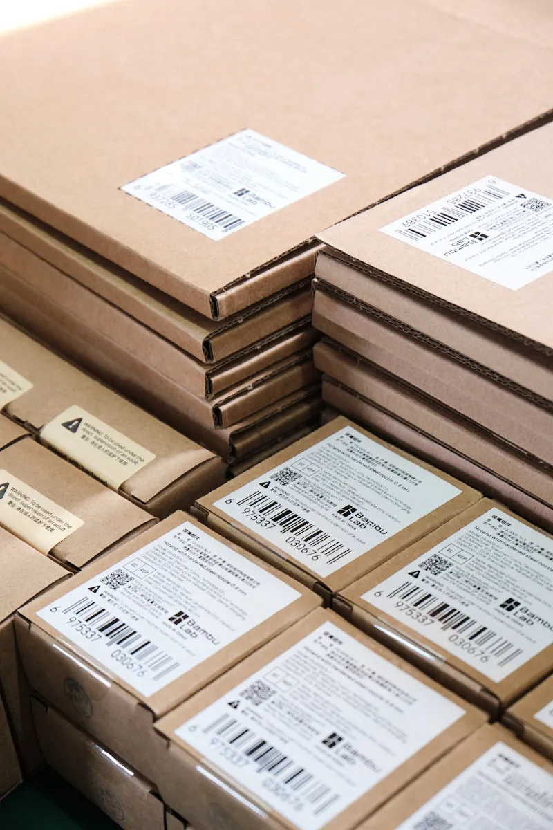 Stacked Bambu Lab parts boxes with labels prepared for bulk wholesale shipment