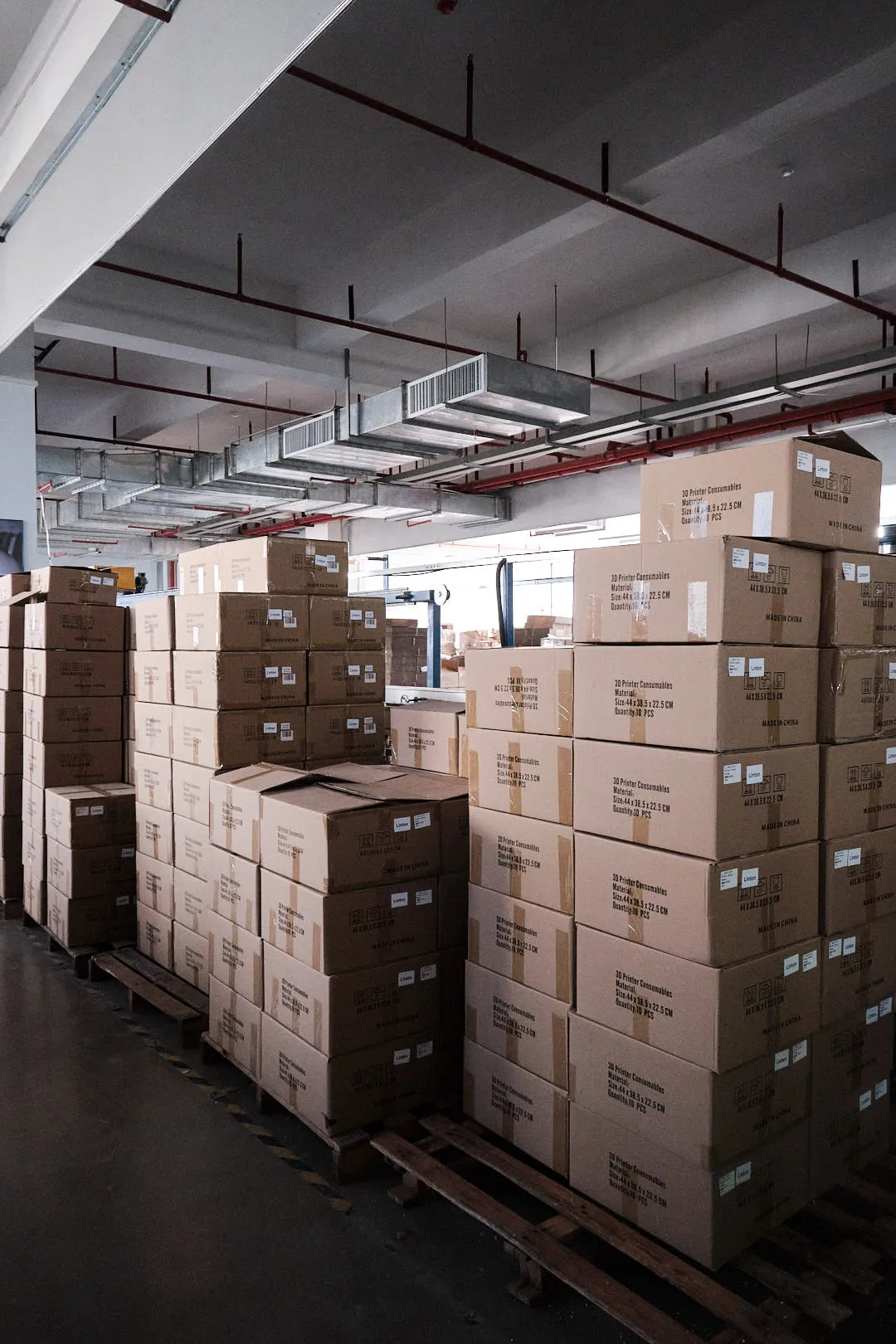 stacked cardboard boxes of 3D printing filament in warehouse ready for bulk shipping