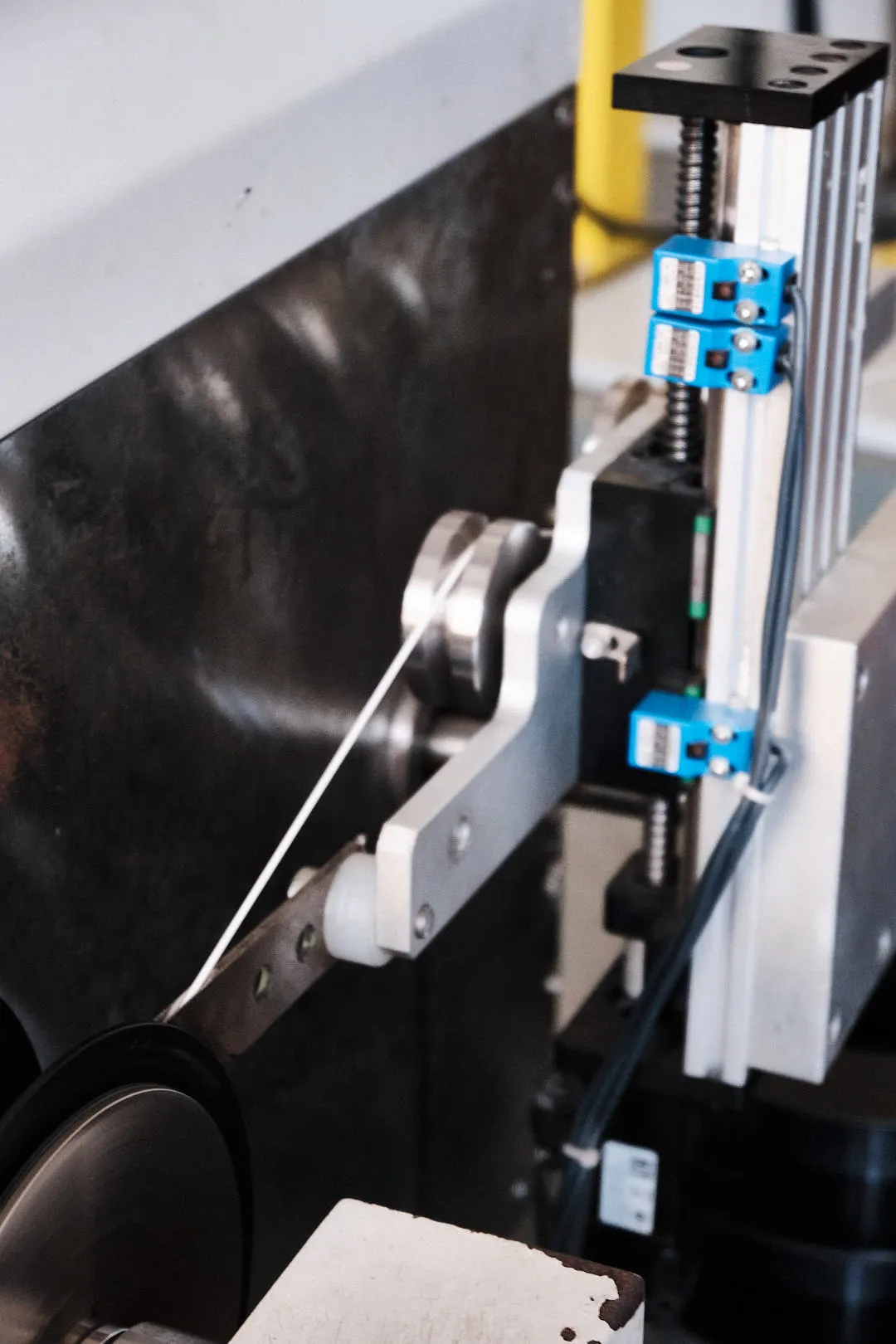3D printing filament guided through rollers and tension control system in production line