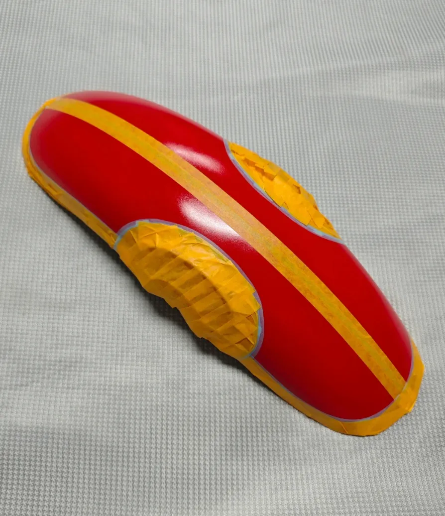 3d printed model with masking tape applied showing protected areas during spray painting process