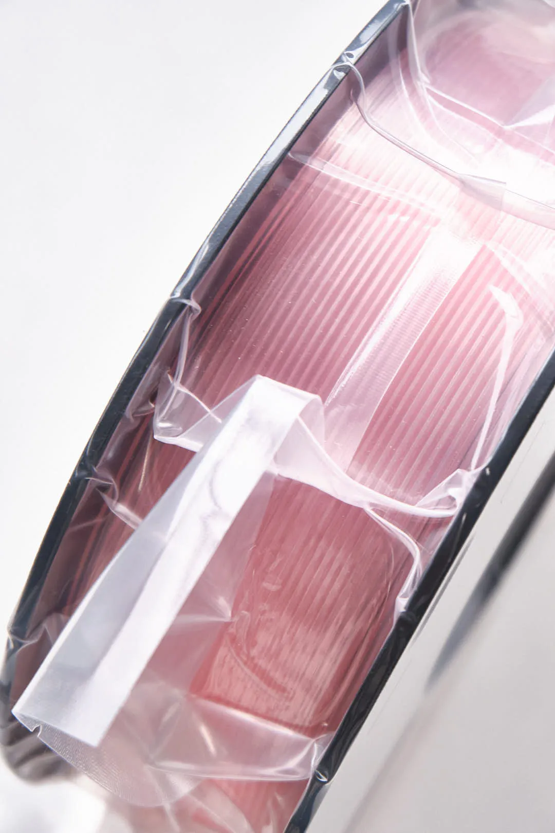 eSun translucent pink PLA filament spool sealed in plastic bag with desiccant visible